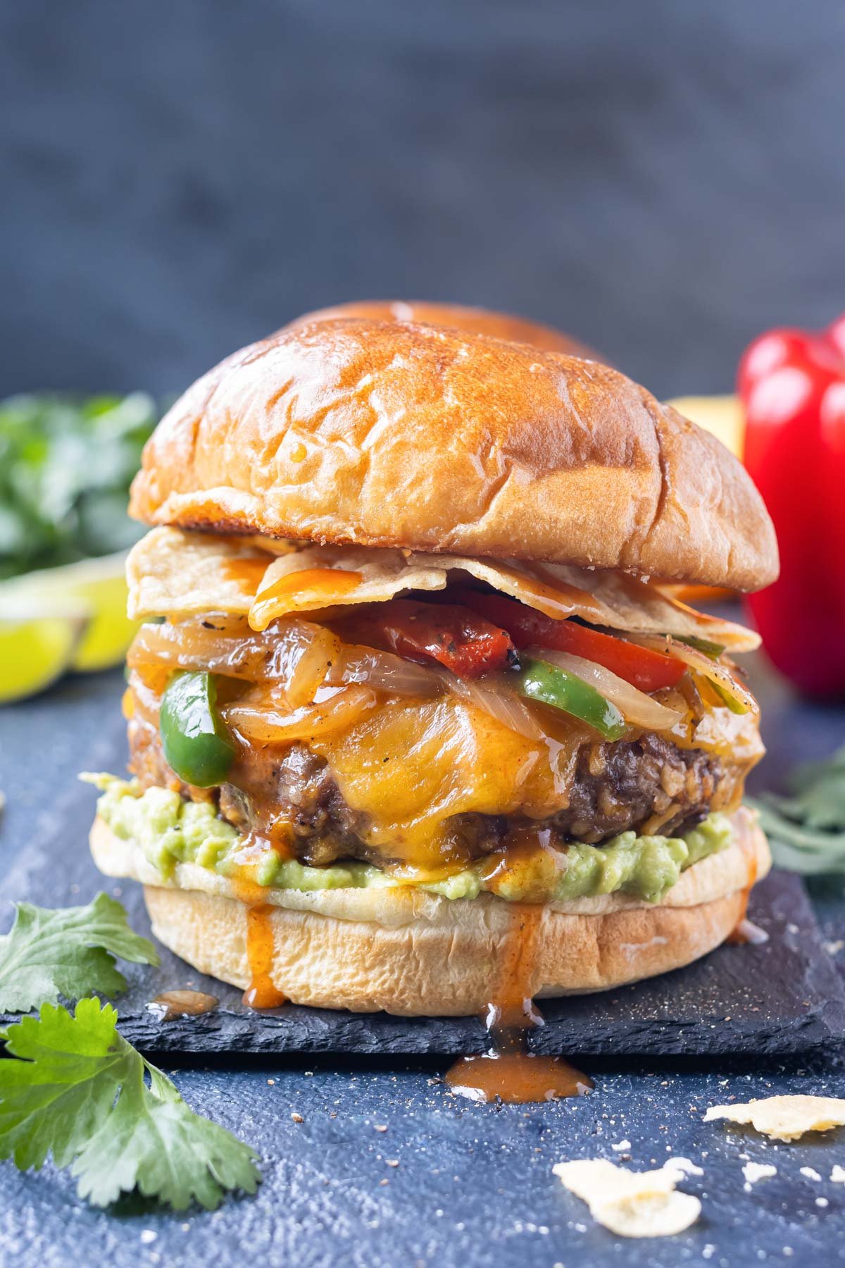 A beef enchilada burger is loaded with your favorite Mexican toppings.