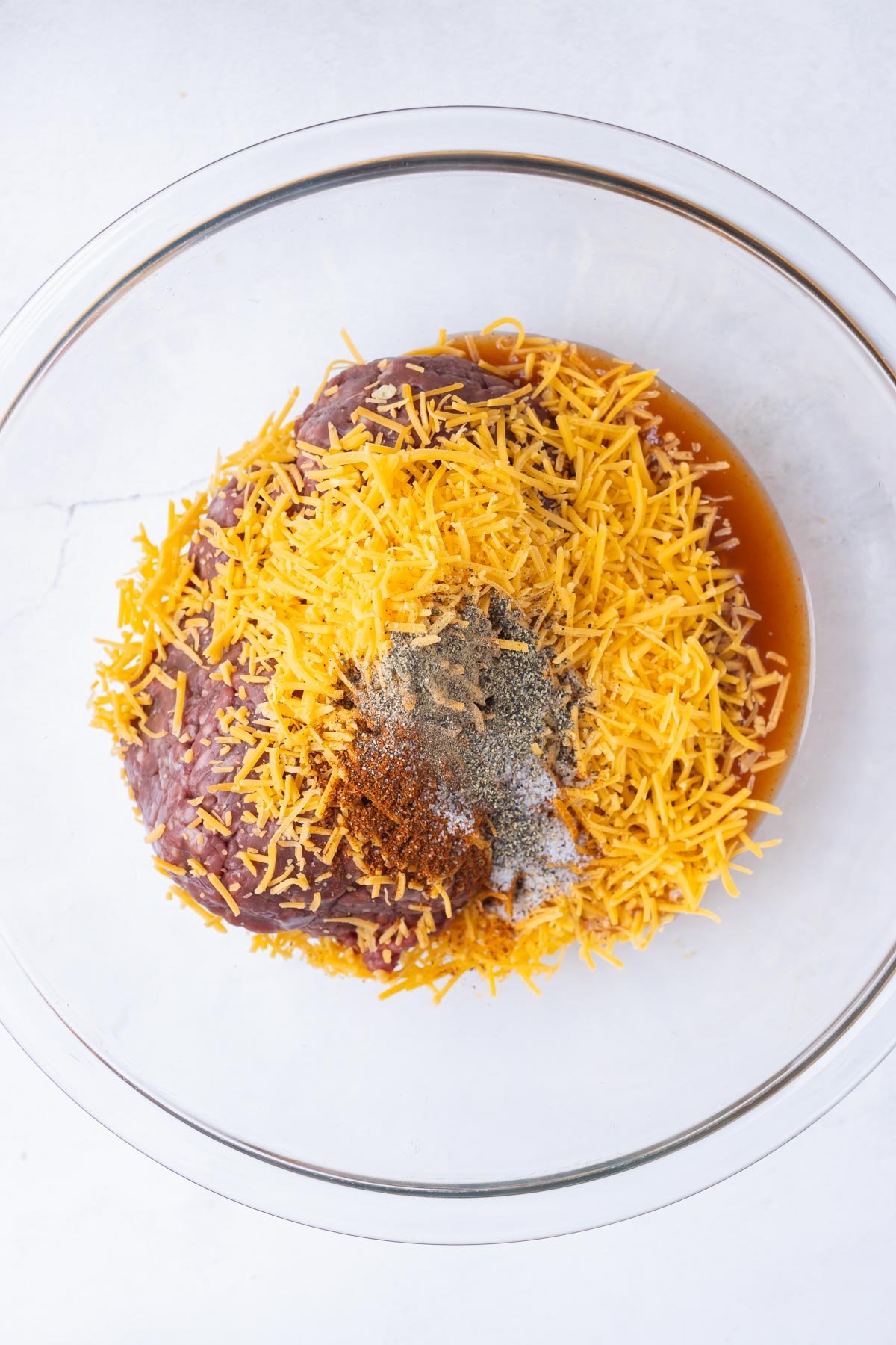 The burger ingredients are added to a bowl.