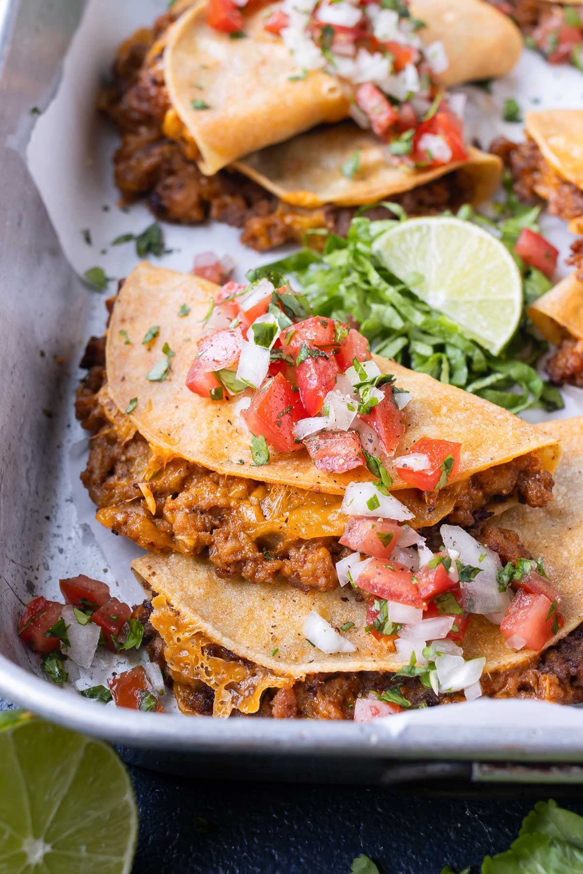 A tray full of crispy baked tacos are served for a quick Taco Tuesday dinner.