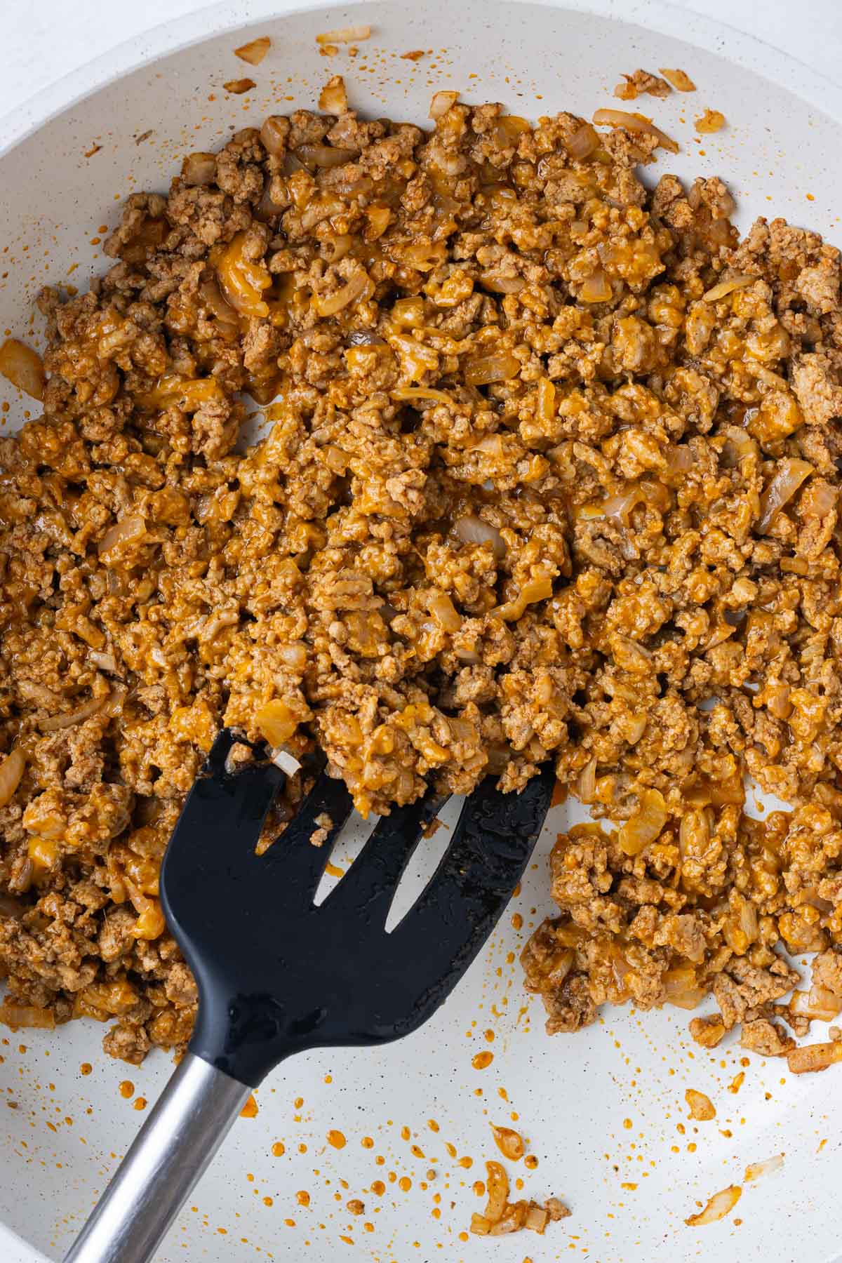 The meat and cheese filling is stirred.