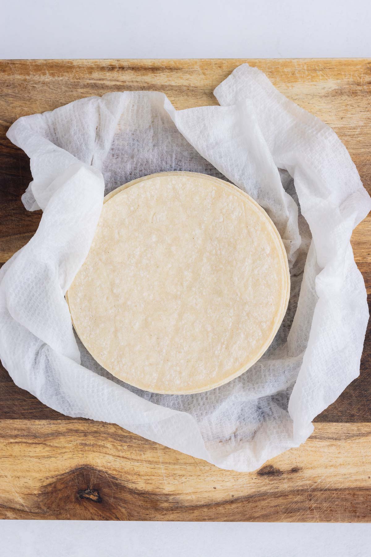 Tortillas are warmed up in a paper towel.