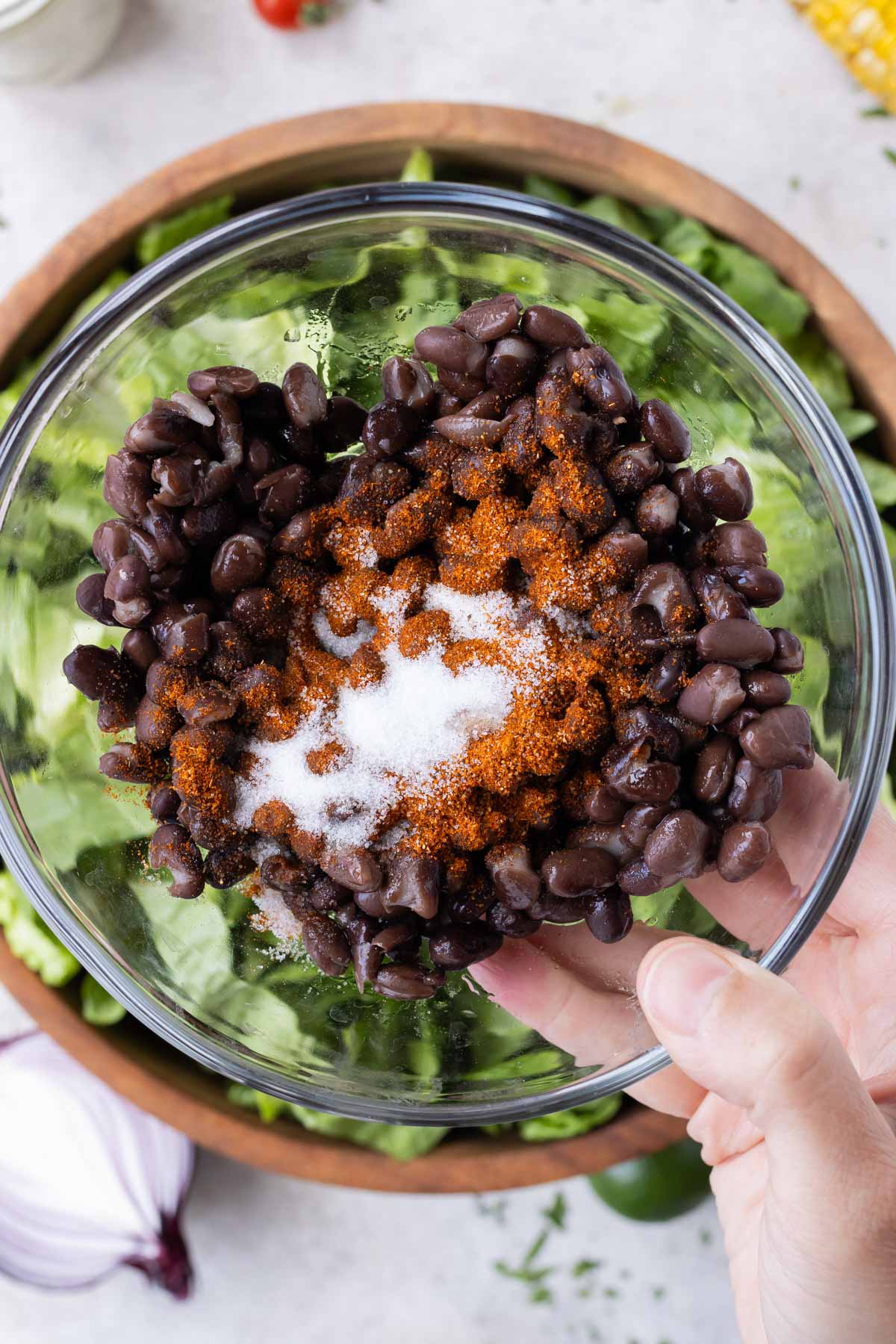 Black beans are seasoned before being added to the salad.