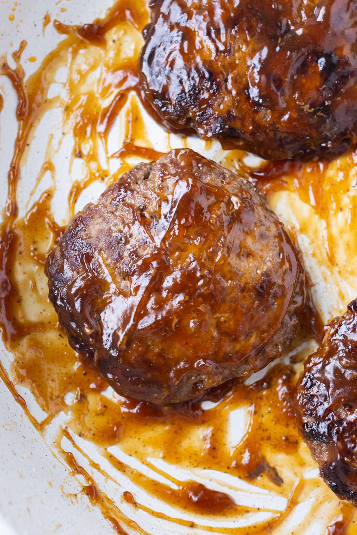 Burgers are cooked in a thickened sauce.