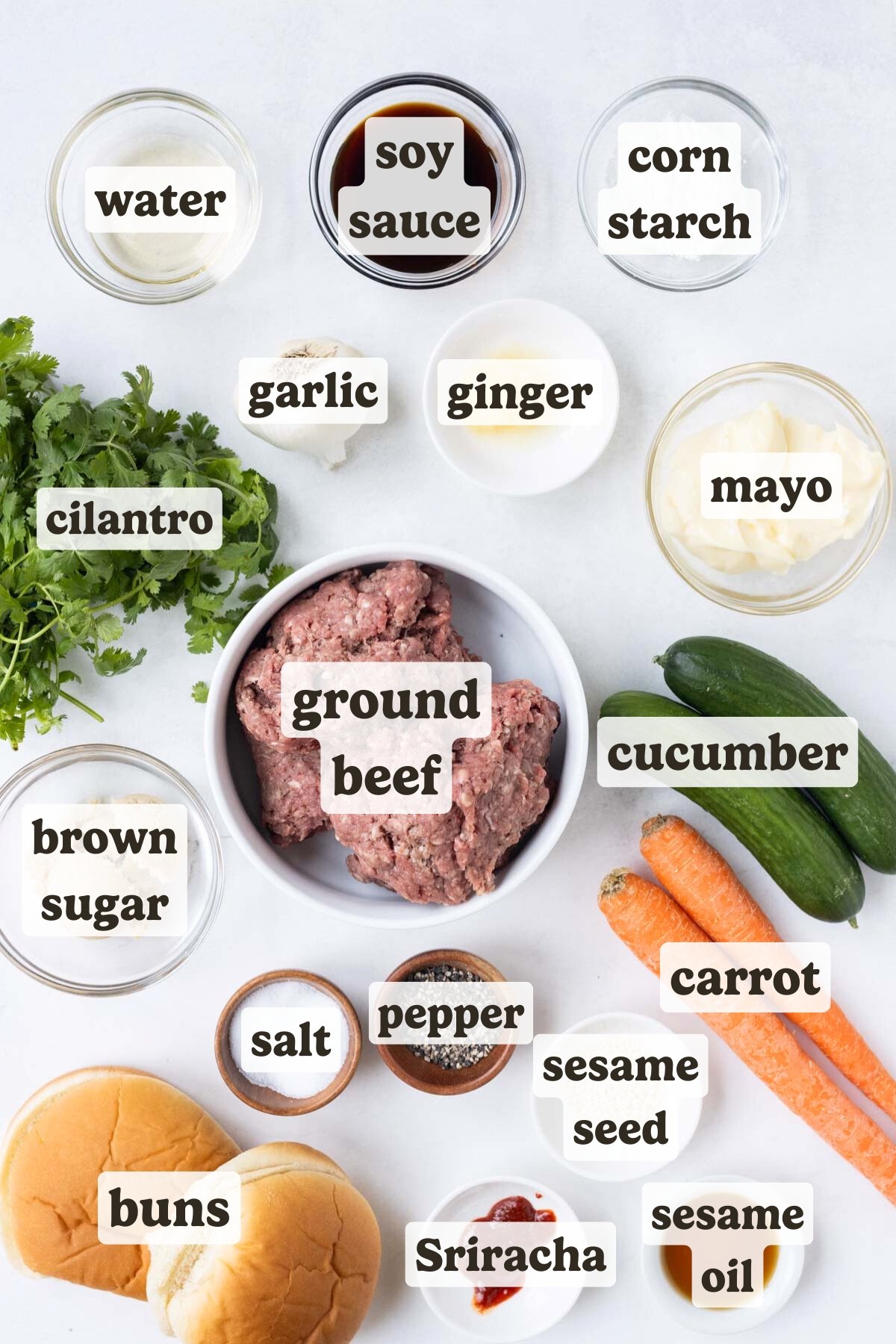Ground beef, carrot, cucumber, buns, and Asian seasonings are the main ingredients for these Korean burgers.