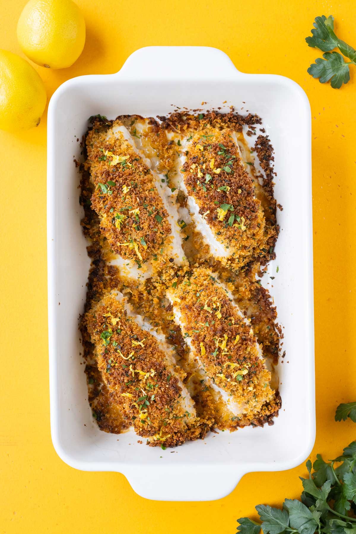 Four filets of cod are coated in Parmesan and Panko and baked in the oven.