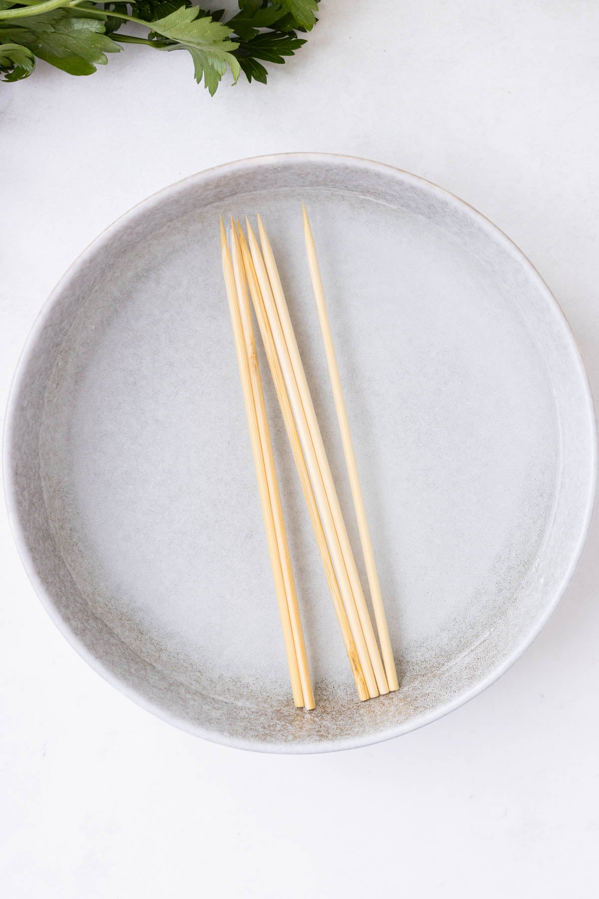 Wooden skewers are soaked in water.