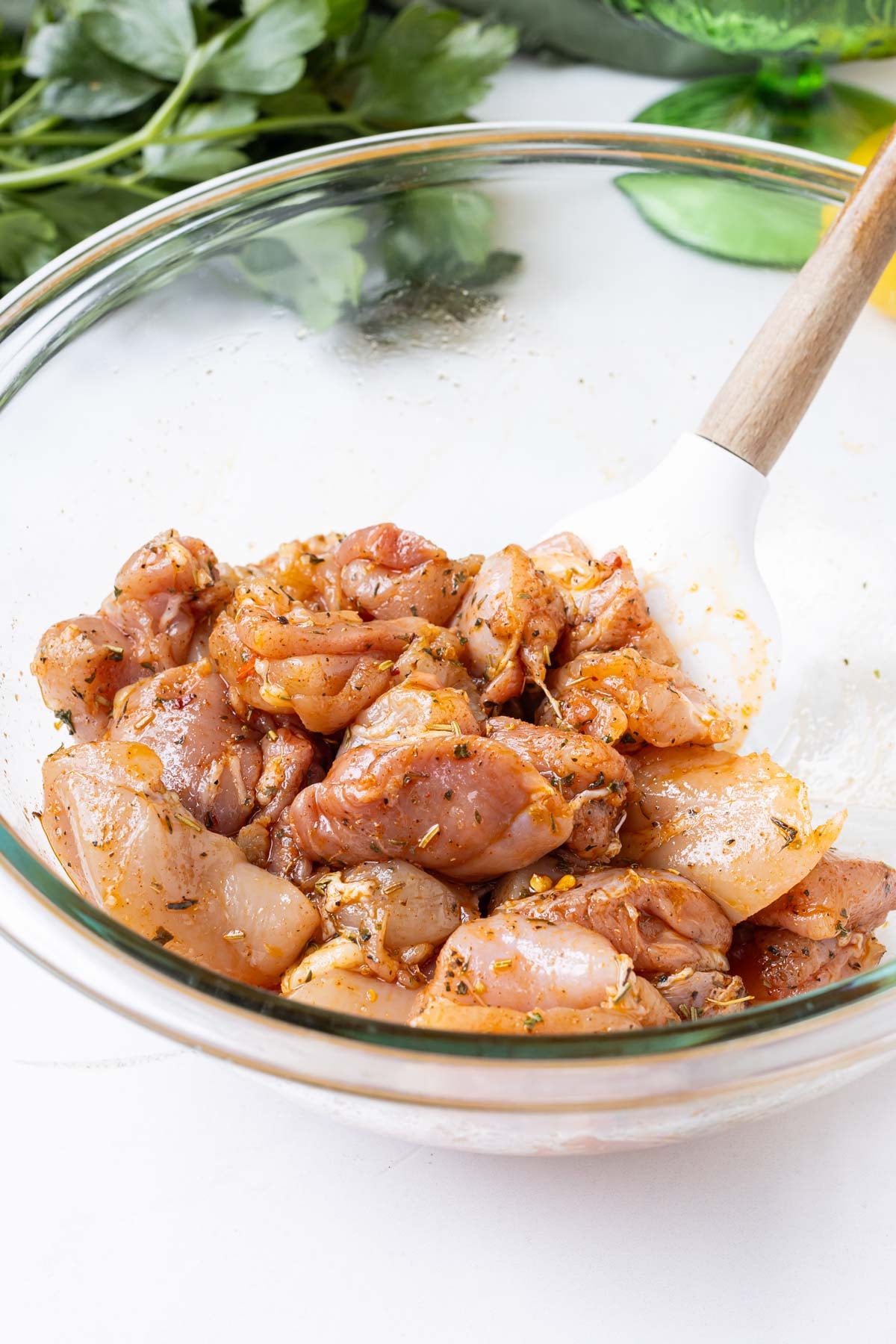 Chicken thighs are cubed then seasoned.