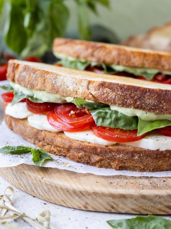 A Caprese Sandwich with fresh basil mayo, tomatoes, and mozzarella on sourdough bread.