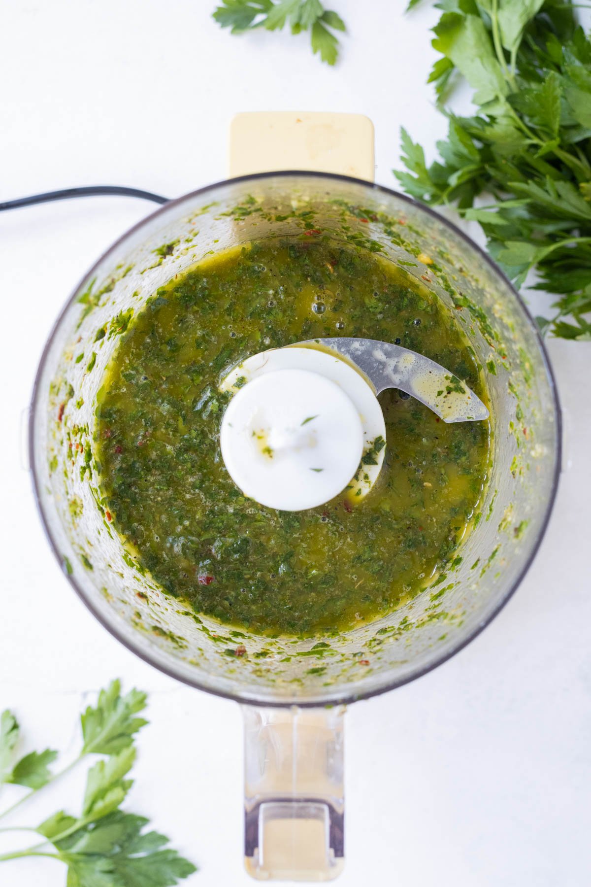 Chimichurri sauce is processed until smooth.