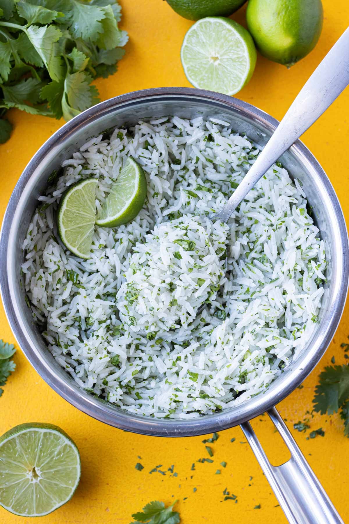 Rice is cooked with coconut milk and cilantro, then topped with lime.