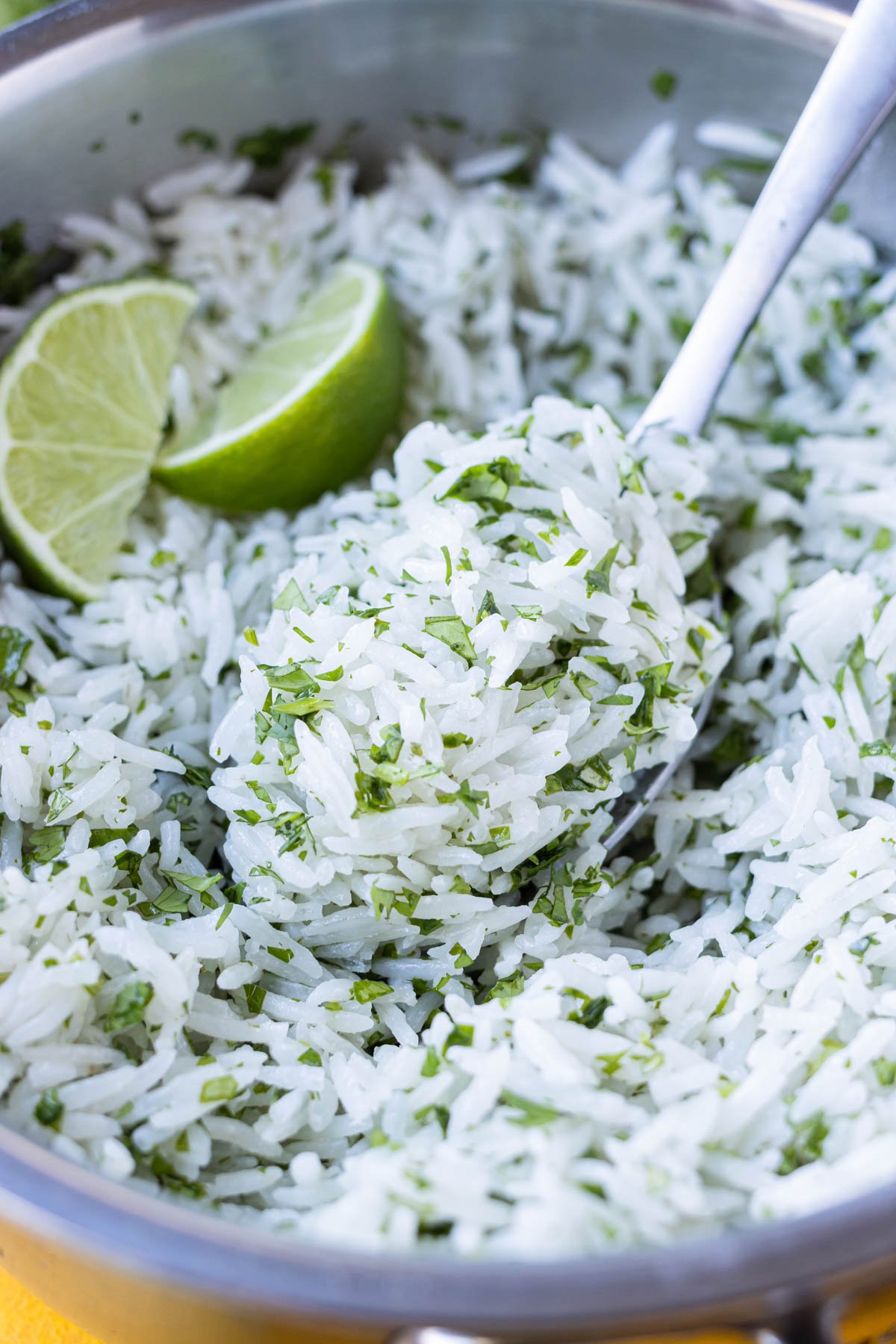Cilantro lime rice that's made with coconut milk is finished cooking in a pot.