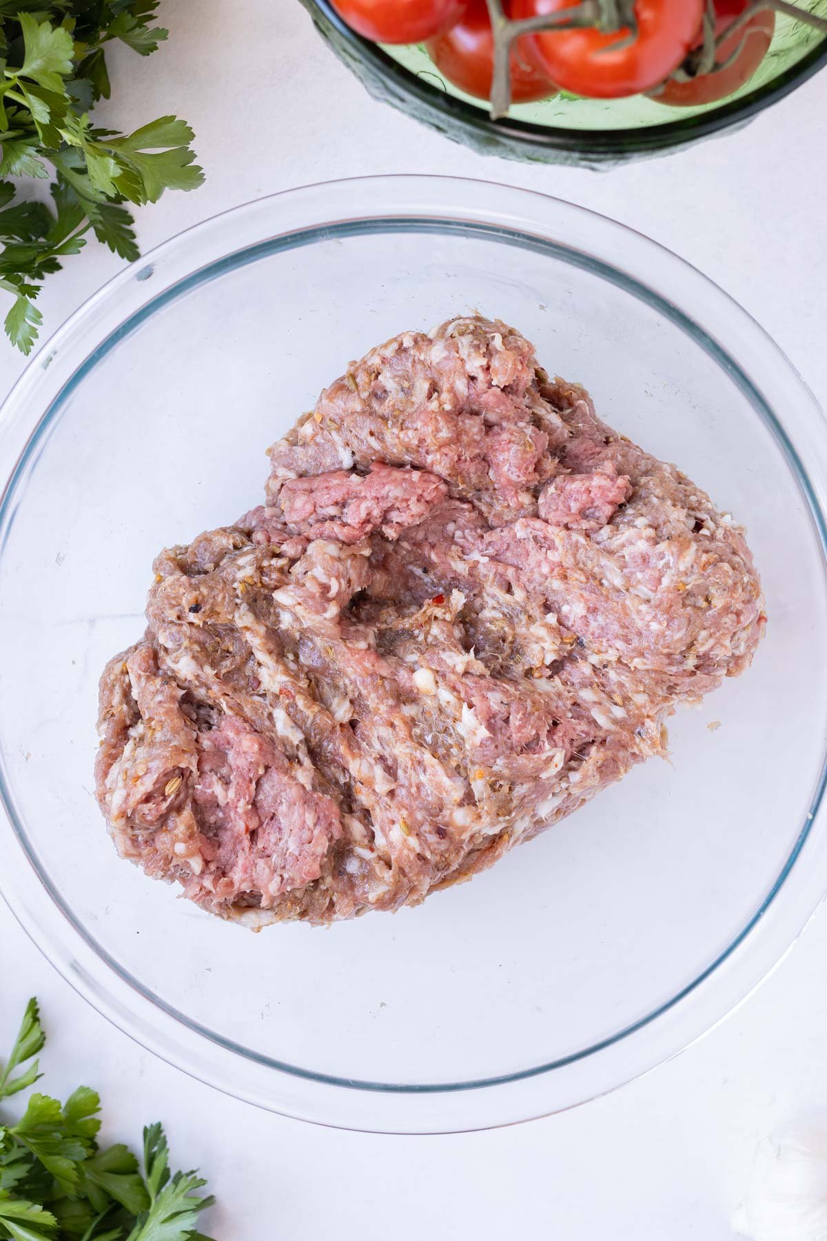 The meatball mixture is mixed together by hand until well combined.