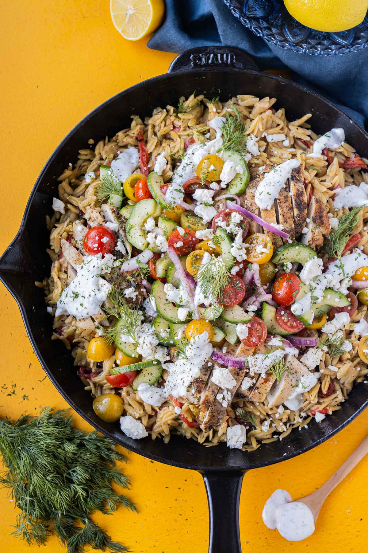 A Greek shawarma chicken is served on top of a creamy orzo for an easy one skillet dinner recipe.