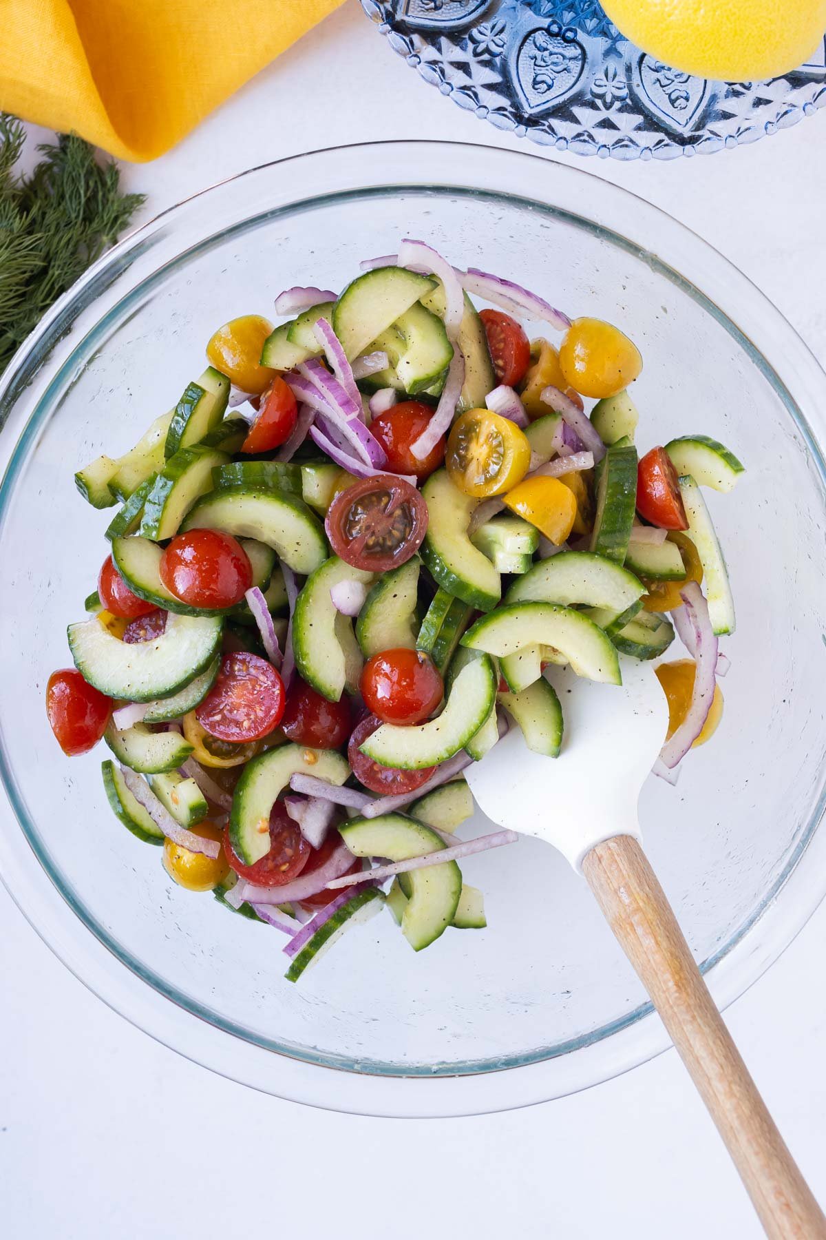 The cucumber, tomatoes, and onions are tossed together.