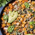 A Sweet Potato Ground Turkey Skillet recipe is served with avocado, jalapenos, and cilantro for dinner.