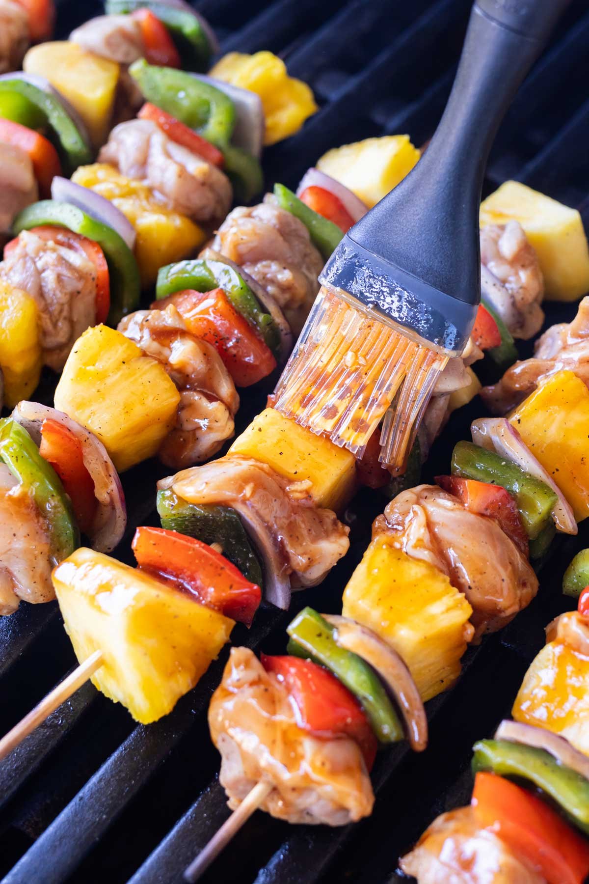 Extra sauce is brushed on the Hawaiian chicken kebabs.