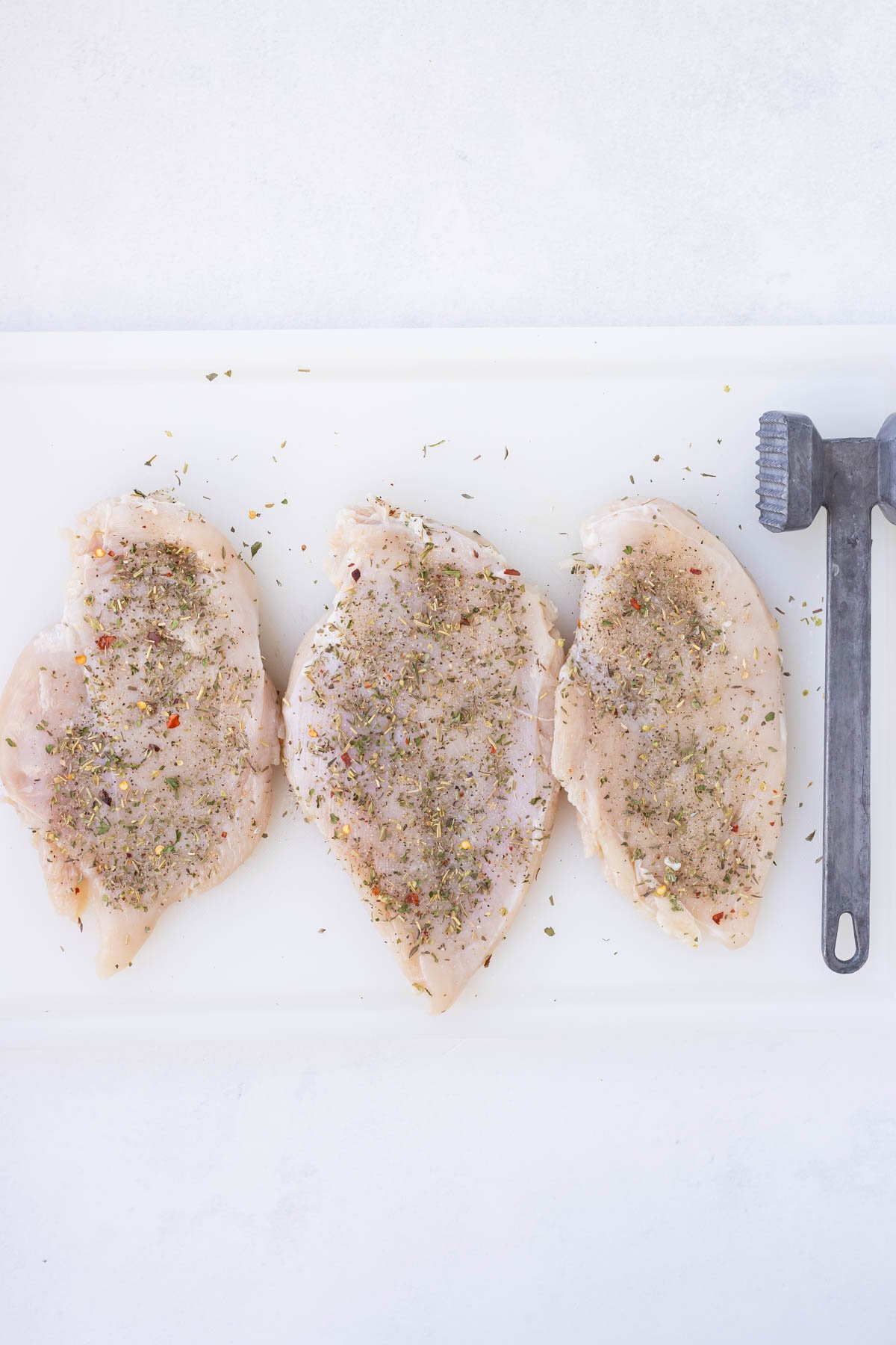 Chicken breasts are pounded thin and seasoned.