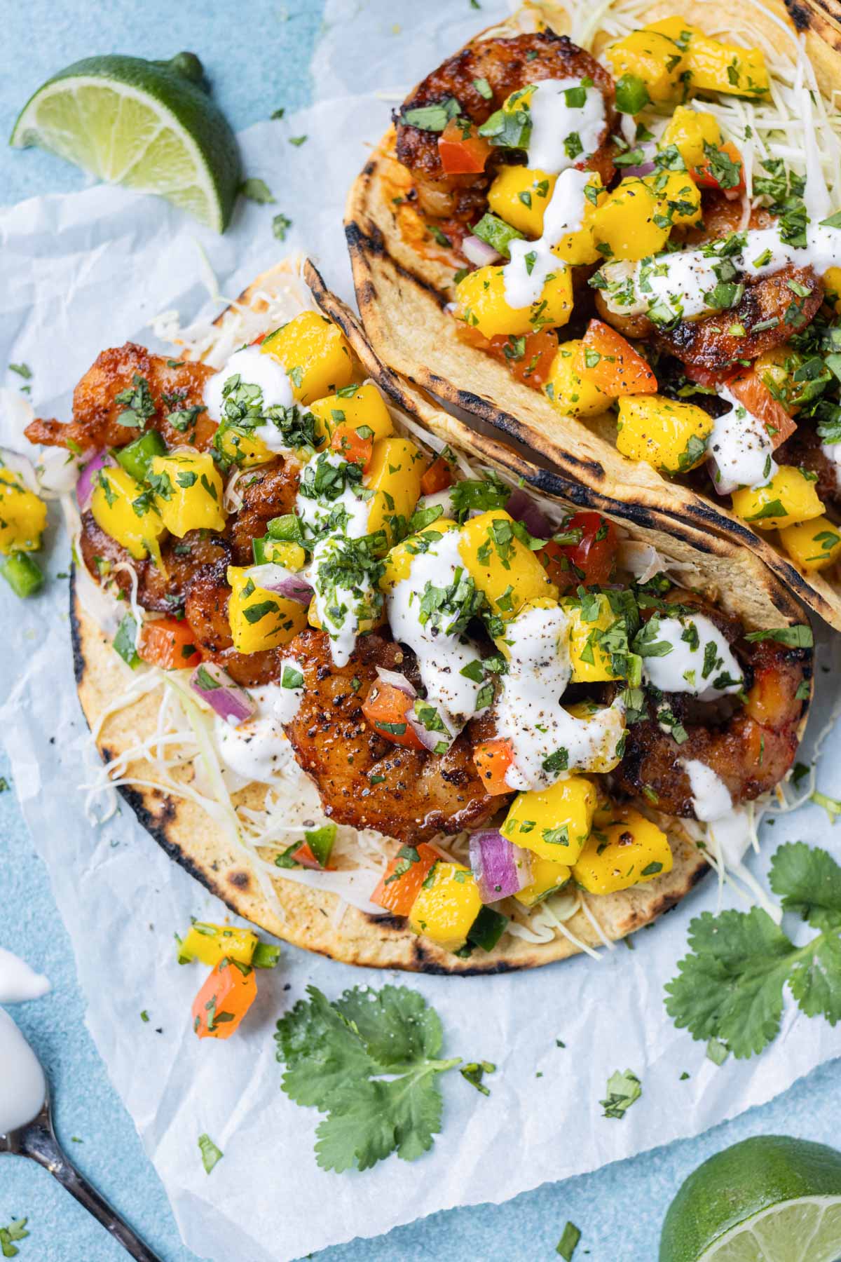 Chili garlic lime shrimp tacos are served with a homemade spicy mango salsa.