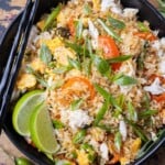A bowl of Thai Crab Fried Rice with bell peppers, Thai basil, and lump crab meat is served with chopsticks.