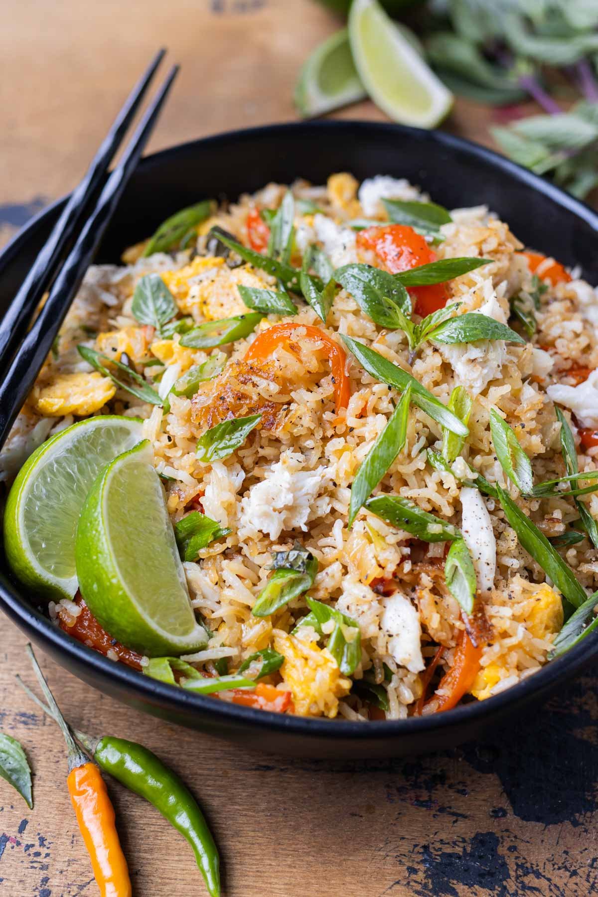 A black bowl is filled with a homemade Thai Basil Crab Fried Rice recipe.