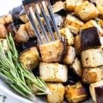 A fork picks up a bite of crispy roasted eggplant.