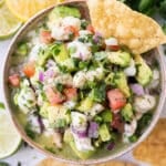 Shrimp Ceviche with Avocado is served with tortilla chips in a white dip bowl.