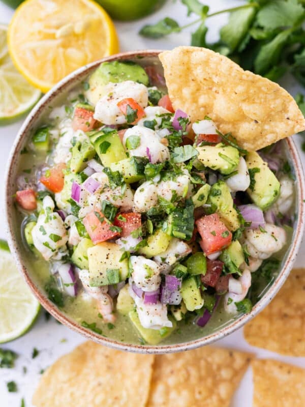 Shrimp Ceviche with Avocado is served with tortilla chips in a white dip bowl.