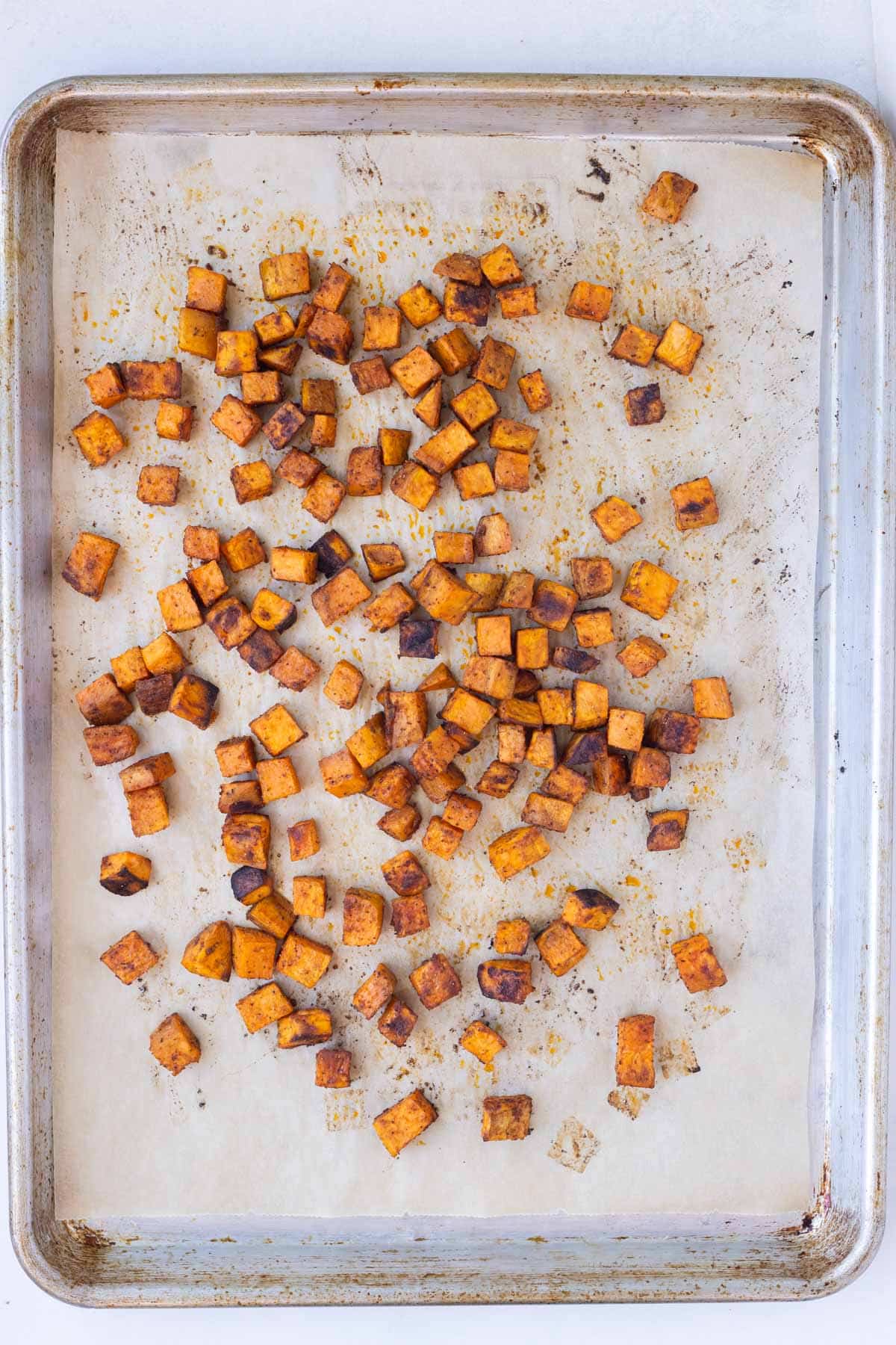 Sweet potatoes are roasted until golden in the oven.