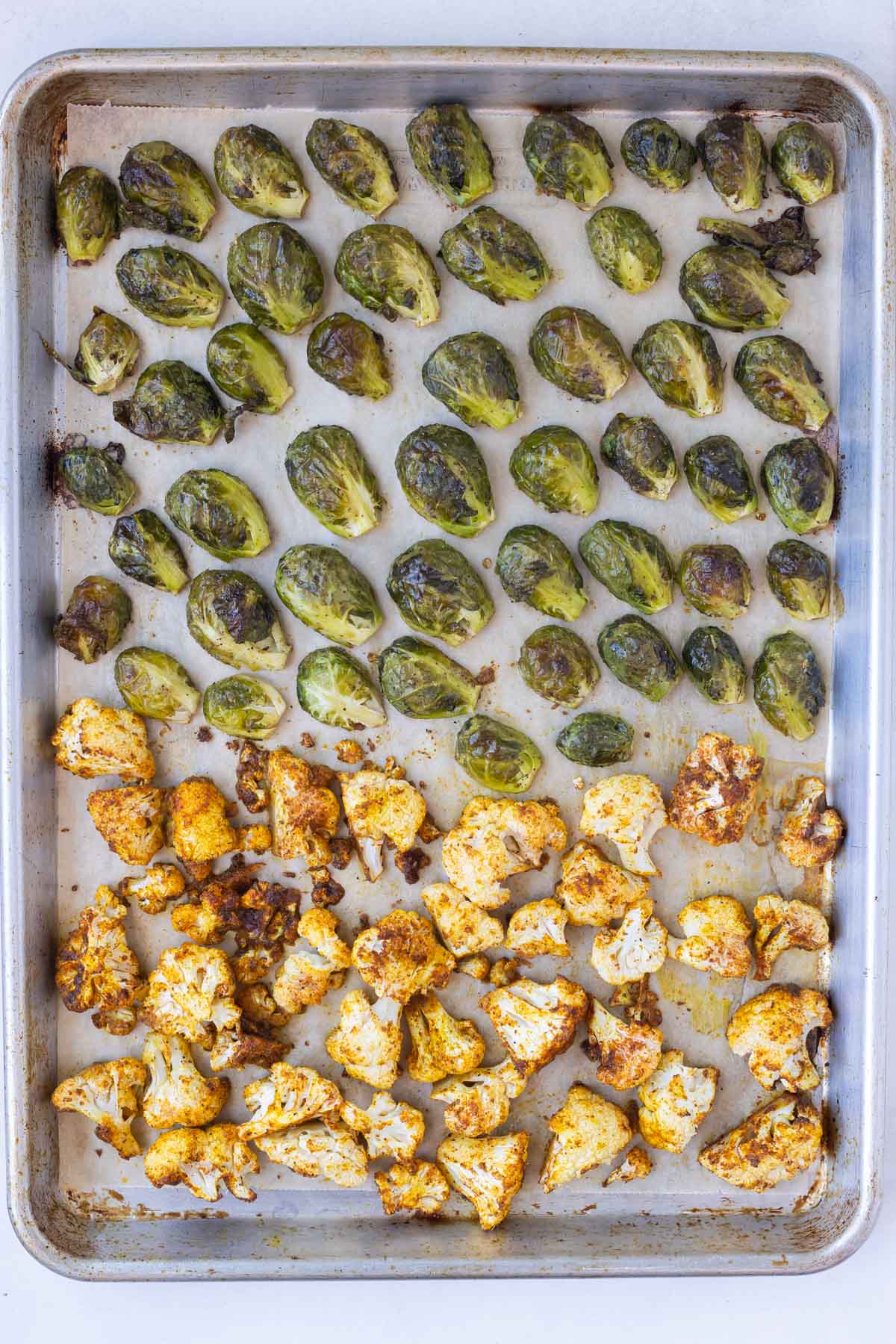 Cauliflower and Brussels sprouts are roasted until golden in the oven.