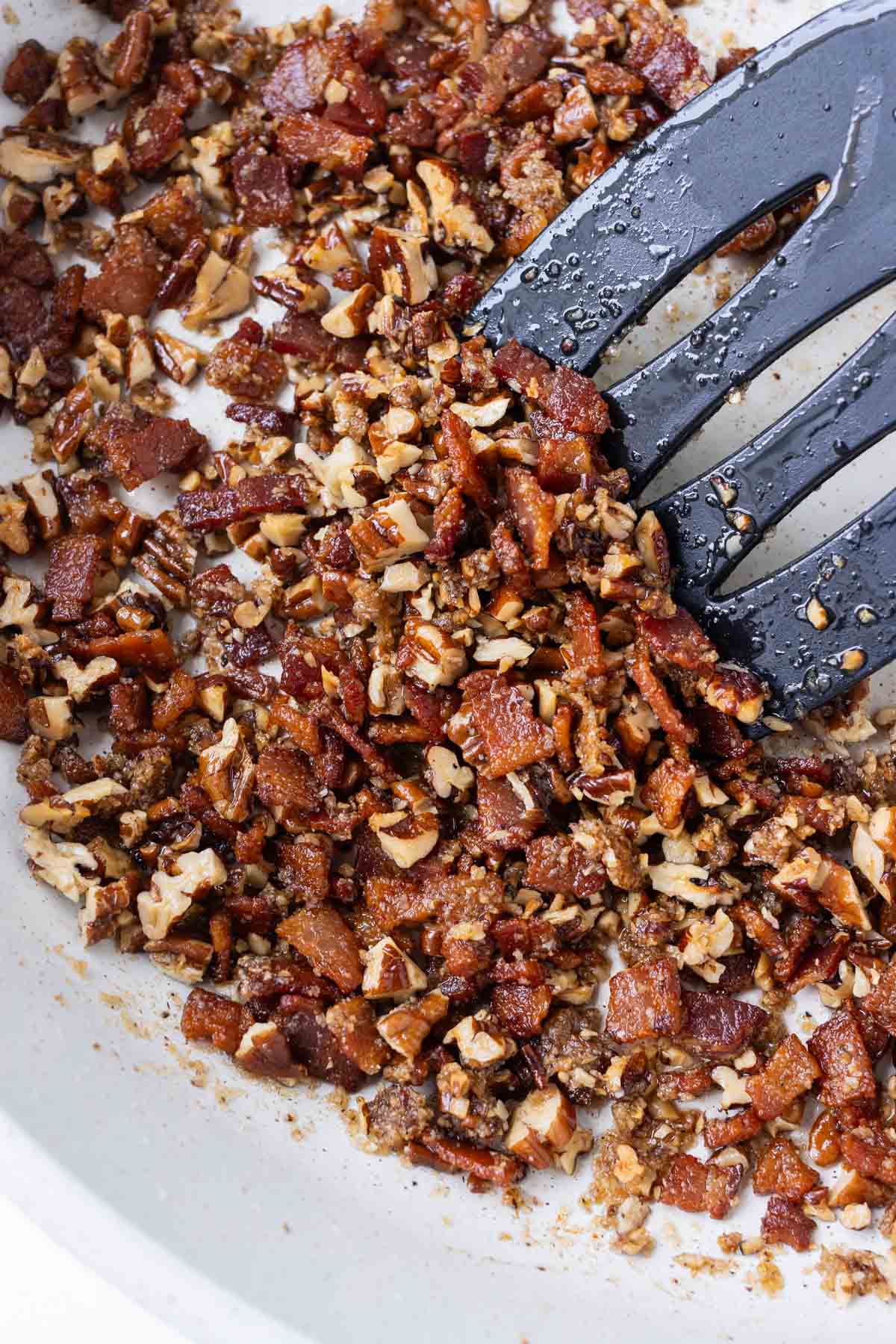 Bacon and pecans are cooked with brown sugar.