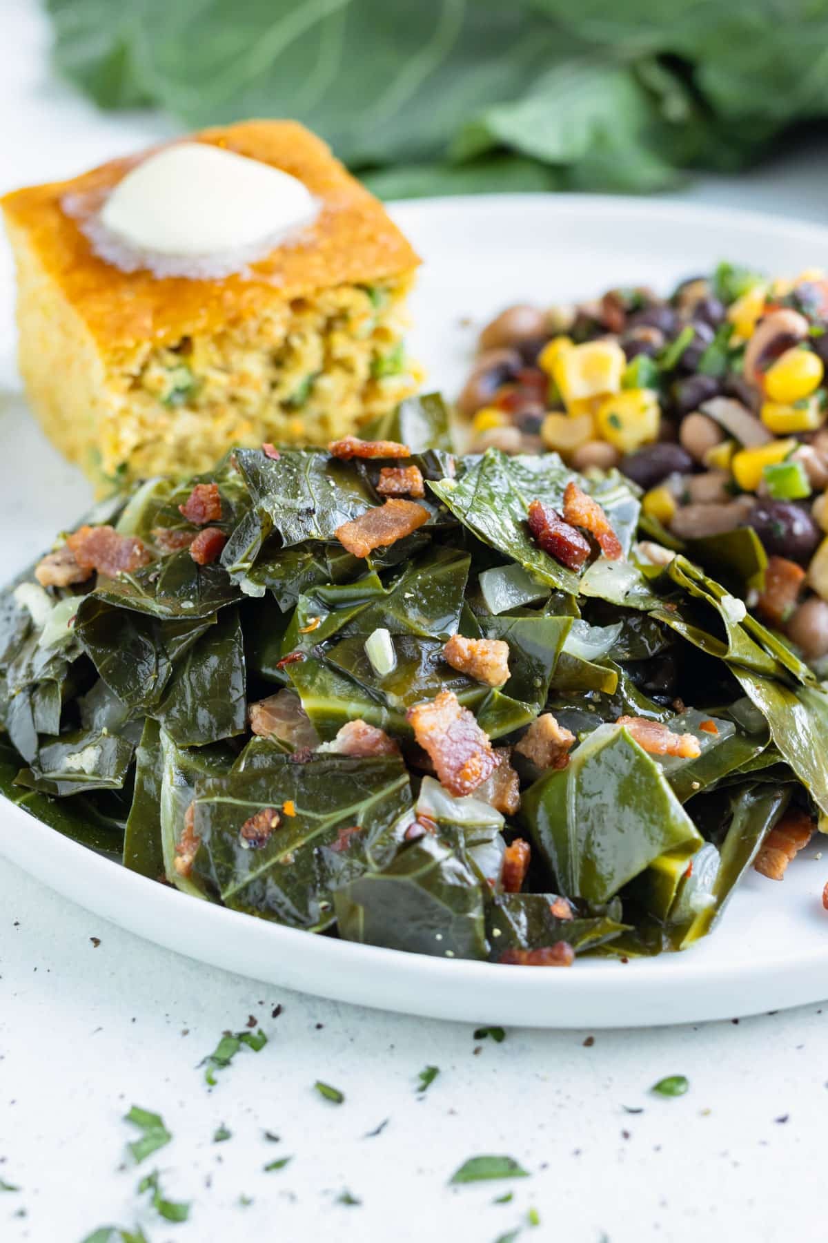 Southern collard greens are served with a side of corn bread.