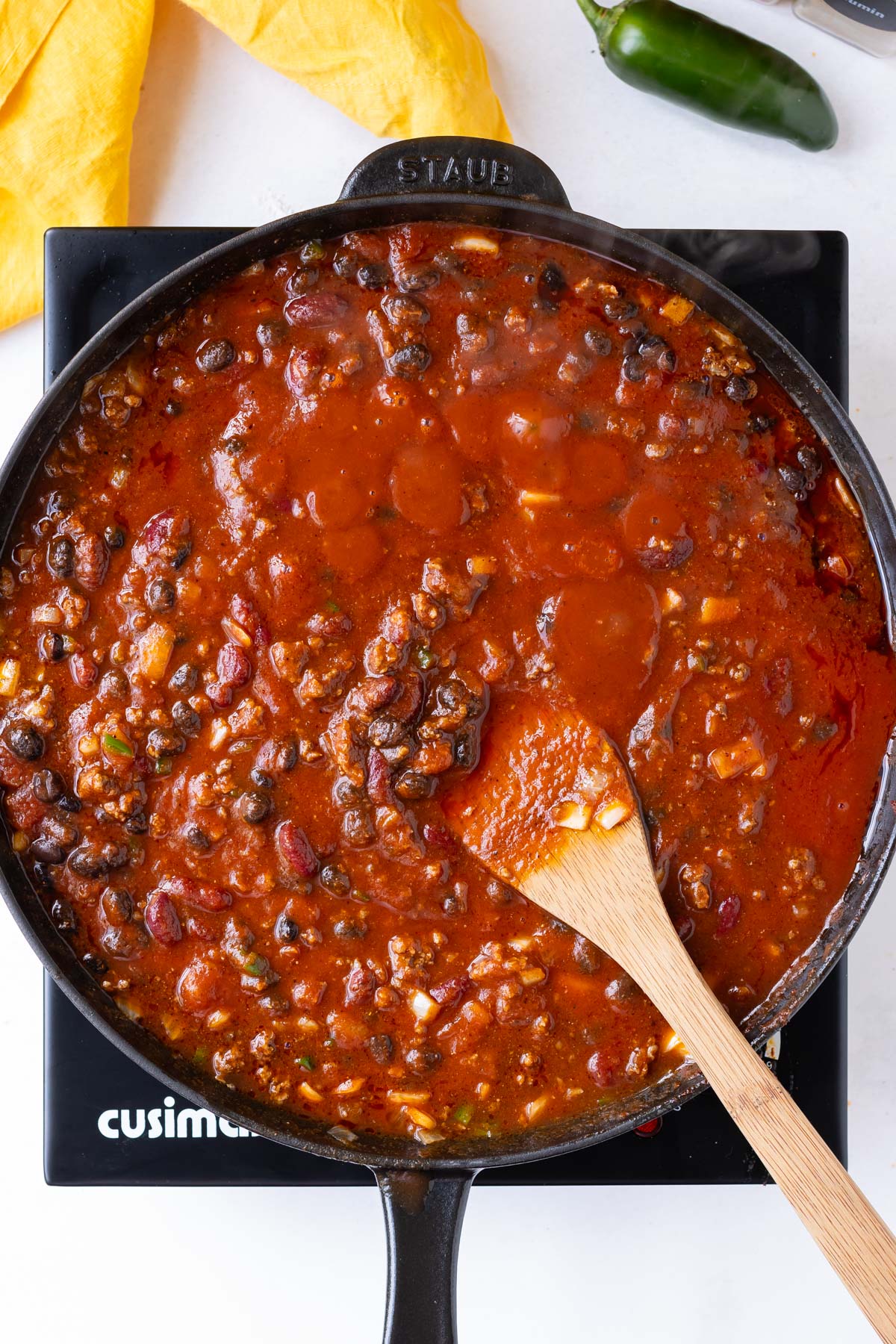 The chili base is simmered in the skillet for the casserole.
