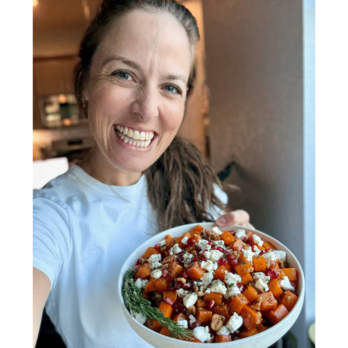 London from Evolving Table holding a bowl of butternut squash and goat cheese.