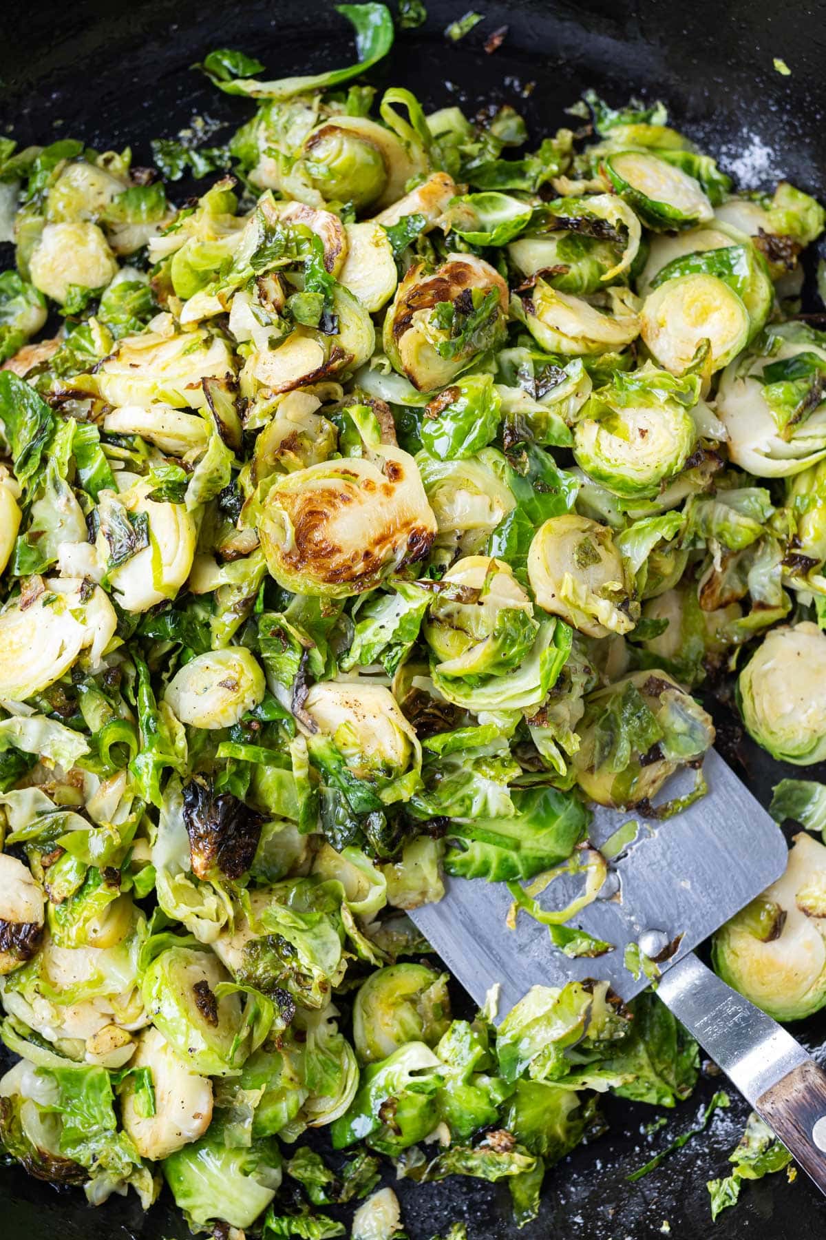 Brussels sprouts are roasted on a baking tray.