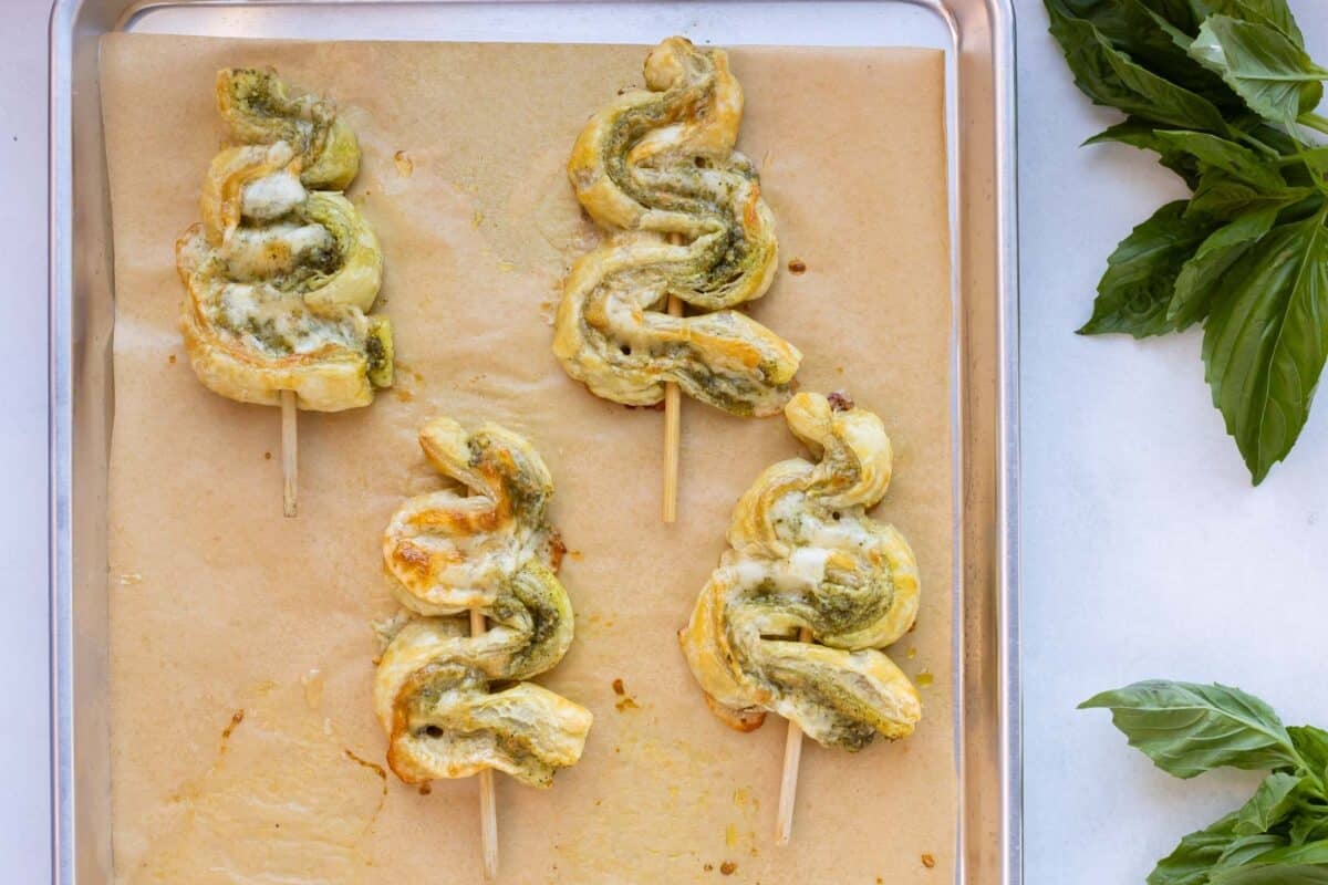 Pesto Puff Pastry Christmas Trees are baked on a sheet.