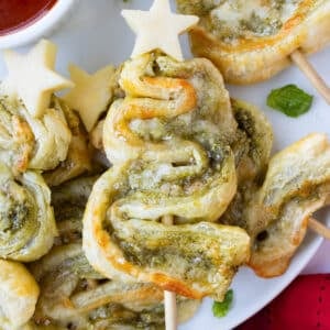 Puff pastry Christmas tree appetizers are filled with pesto sauce and provolone cheese for an easy holiday appetizer.