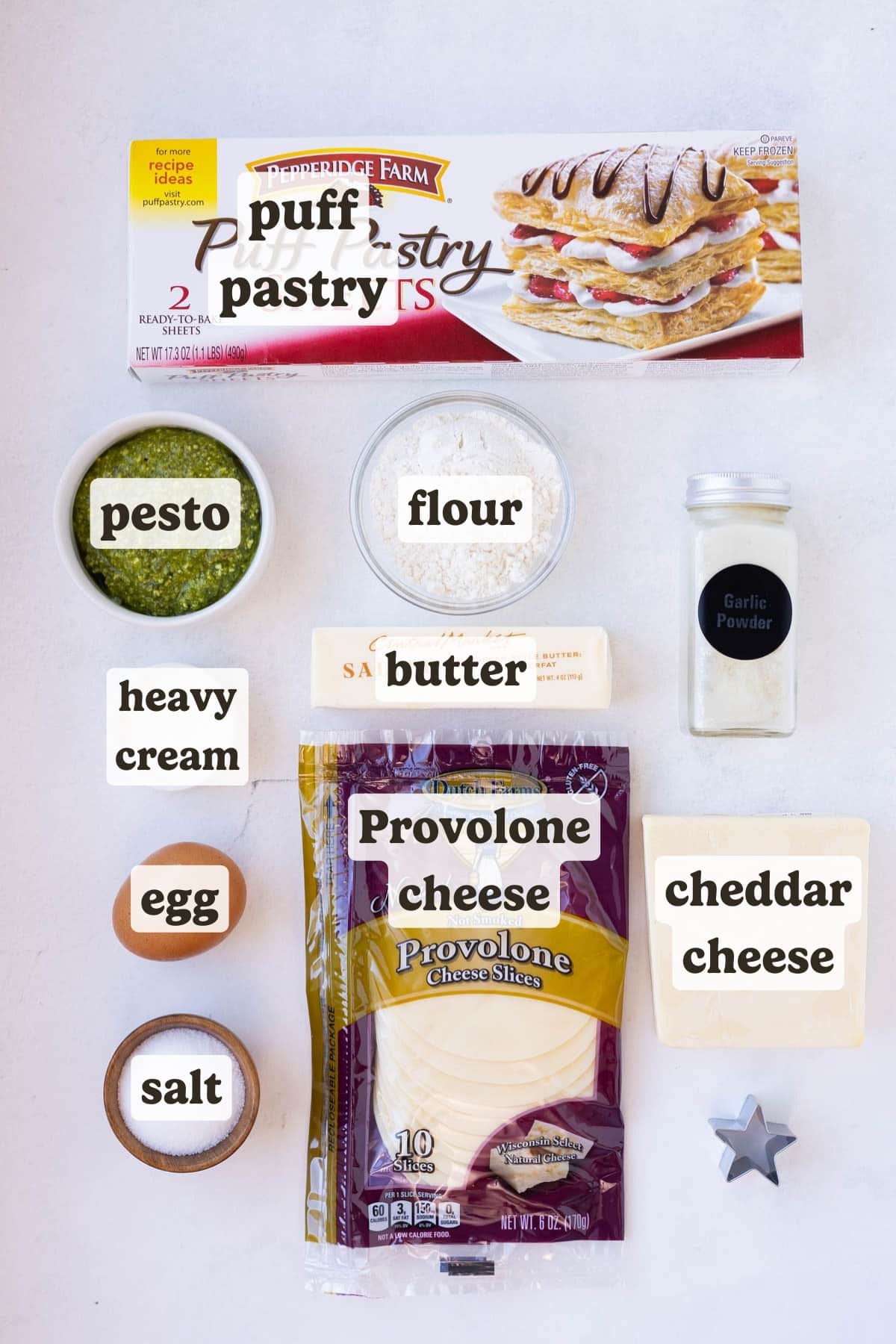 Puff pastry, pesto, butter, cheese, egg, and seasonings are the main ingredients for these pesto puff pastry Christmas trees.