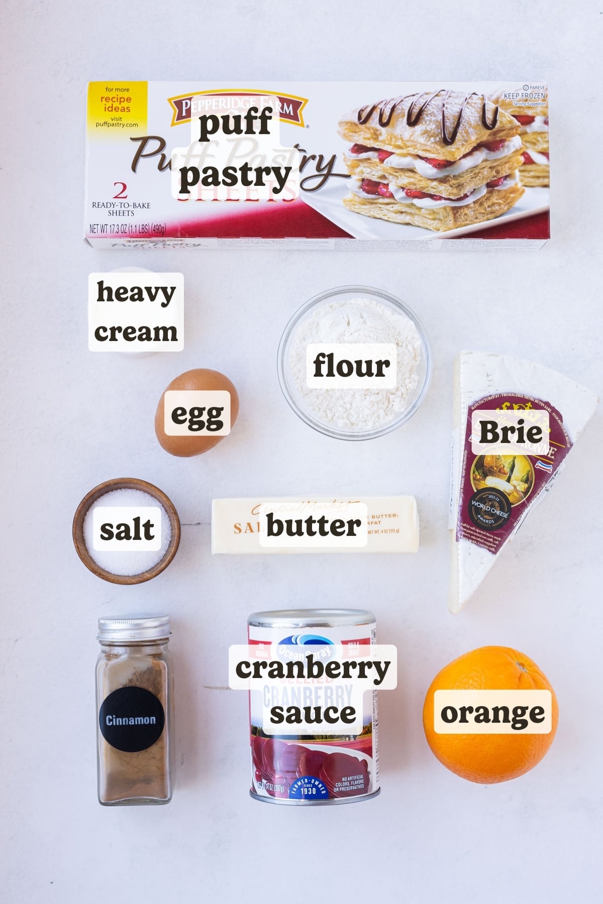Puff pastry, cranberry sauce, orange, butter, sugar, brie, and seasonings are the main ingredients for this cranberry brie puff pastry recipe.