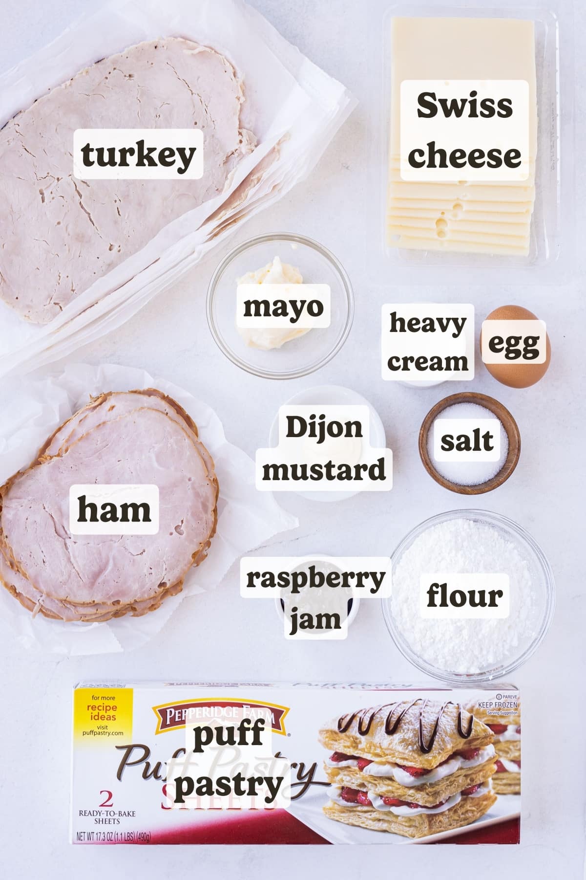 Puff pastry, ham, turkey, Swiss cheese, egg, mustard, and raspberry jam are the main ingredients for these Monte Cristo puff pastry pinwheels.