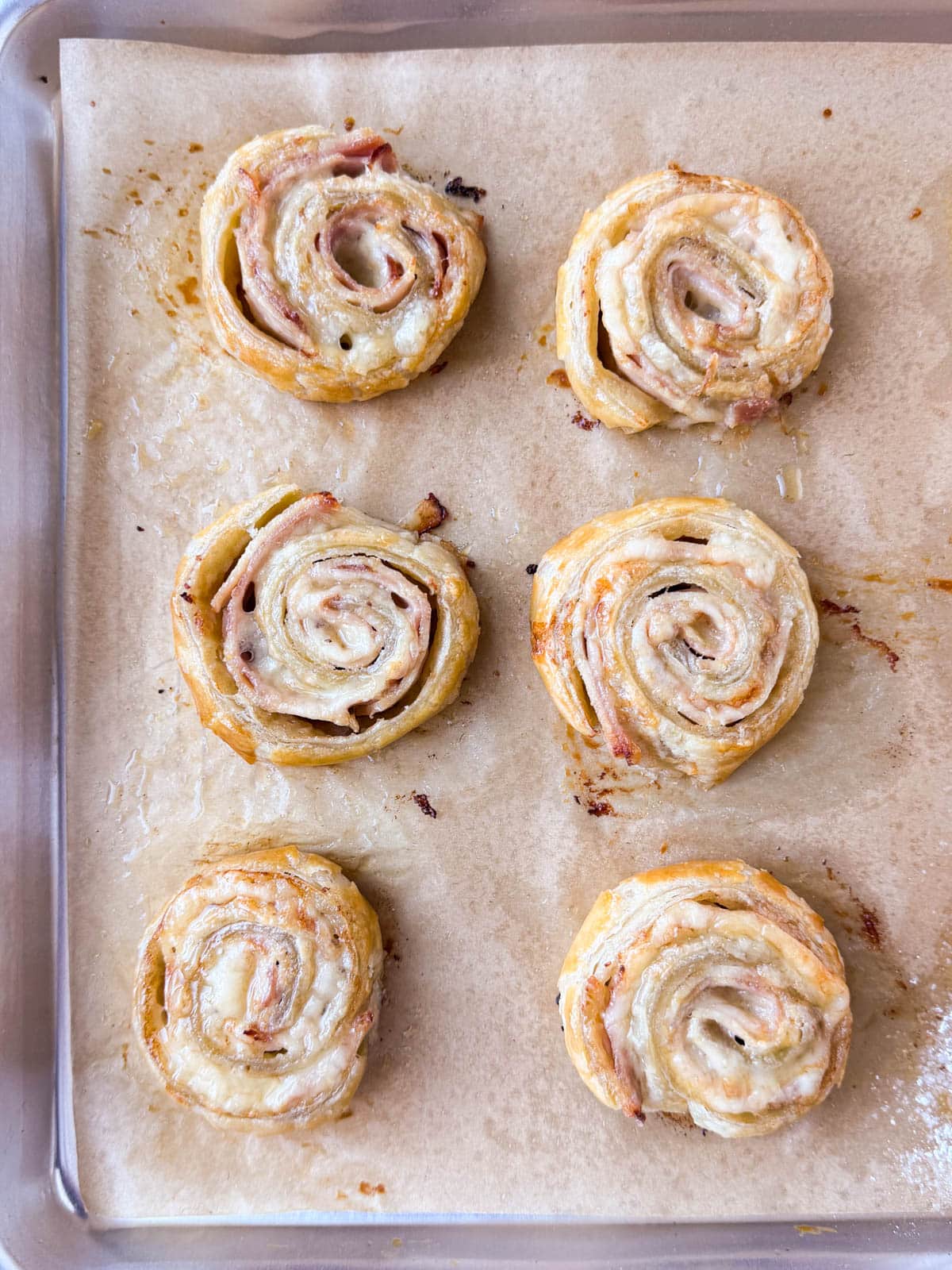 Puff pastry Monte Cristos are baked in the oven.