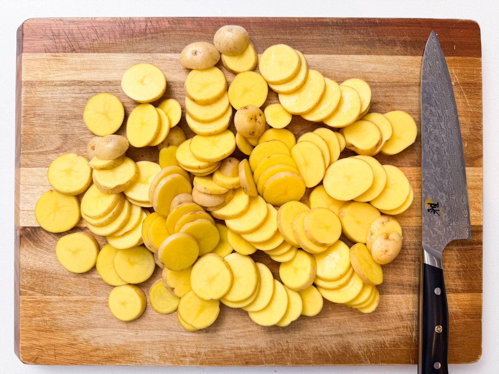 Potatoes are sliced before cooking.