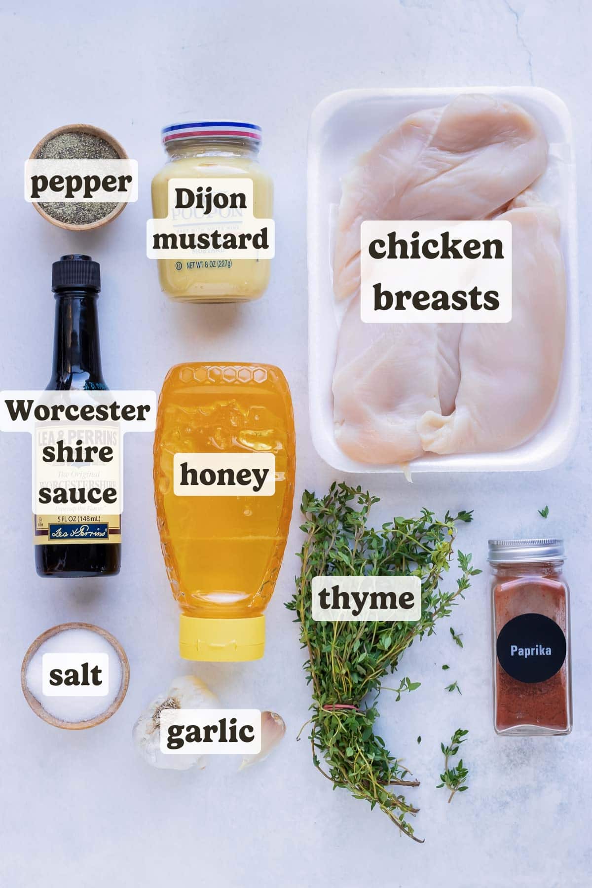 Honey, mustard, thyme, paprika, salt, and garlic as ingredients for this honey mustard chicken recipe.