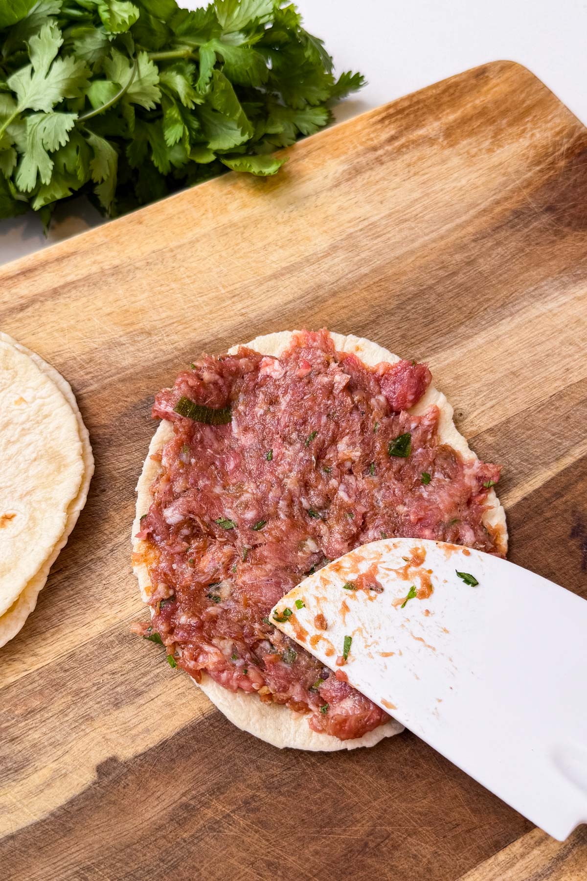 The meat mixture is spread onto street taco size tortillas.