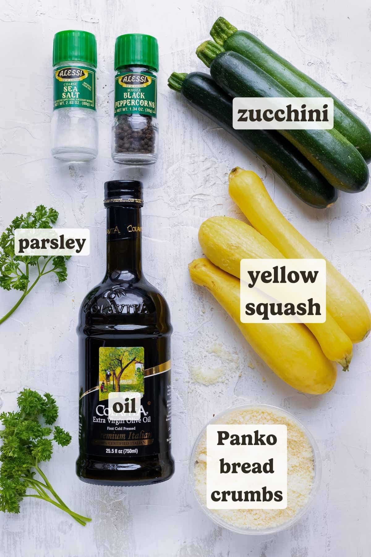 Zucchini, yellow squash, salt, pepper, onion, oil, and garlic ingredients for a squash casserole side dish recipe.