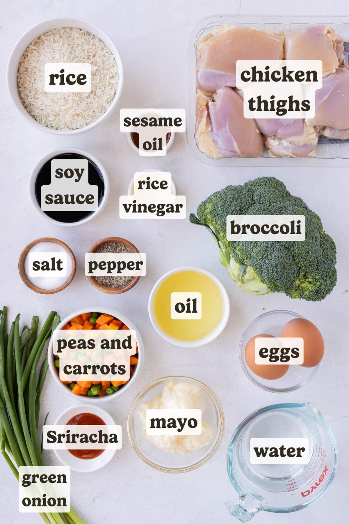 Rice, chicken thighs, vegetables, eggs, soy sauce, mayo, and Sriracha are the main ingredients for this chicken fried rice dish.