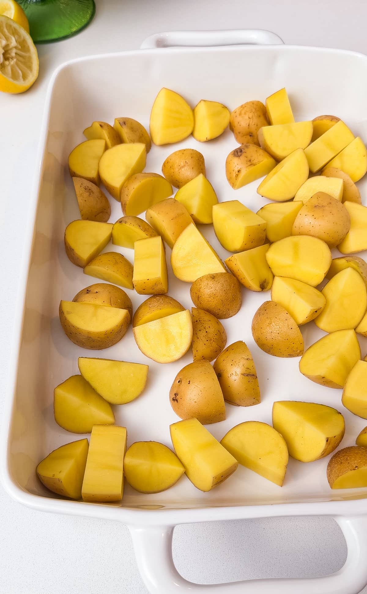 Potatoes are spread in a baking dish.