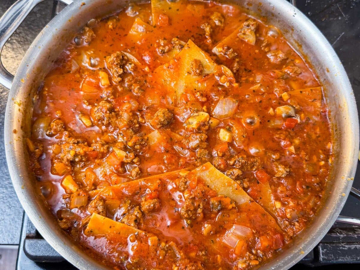 No boil noodles are added to the sauce and meat base of this lasagna.