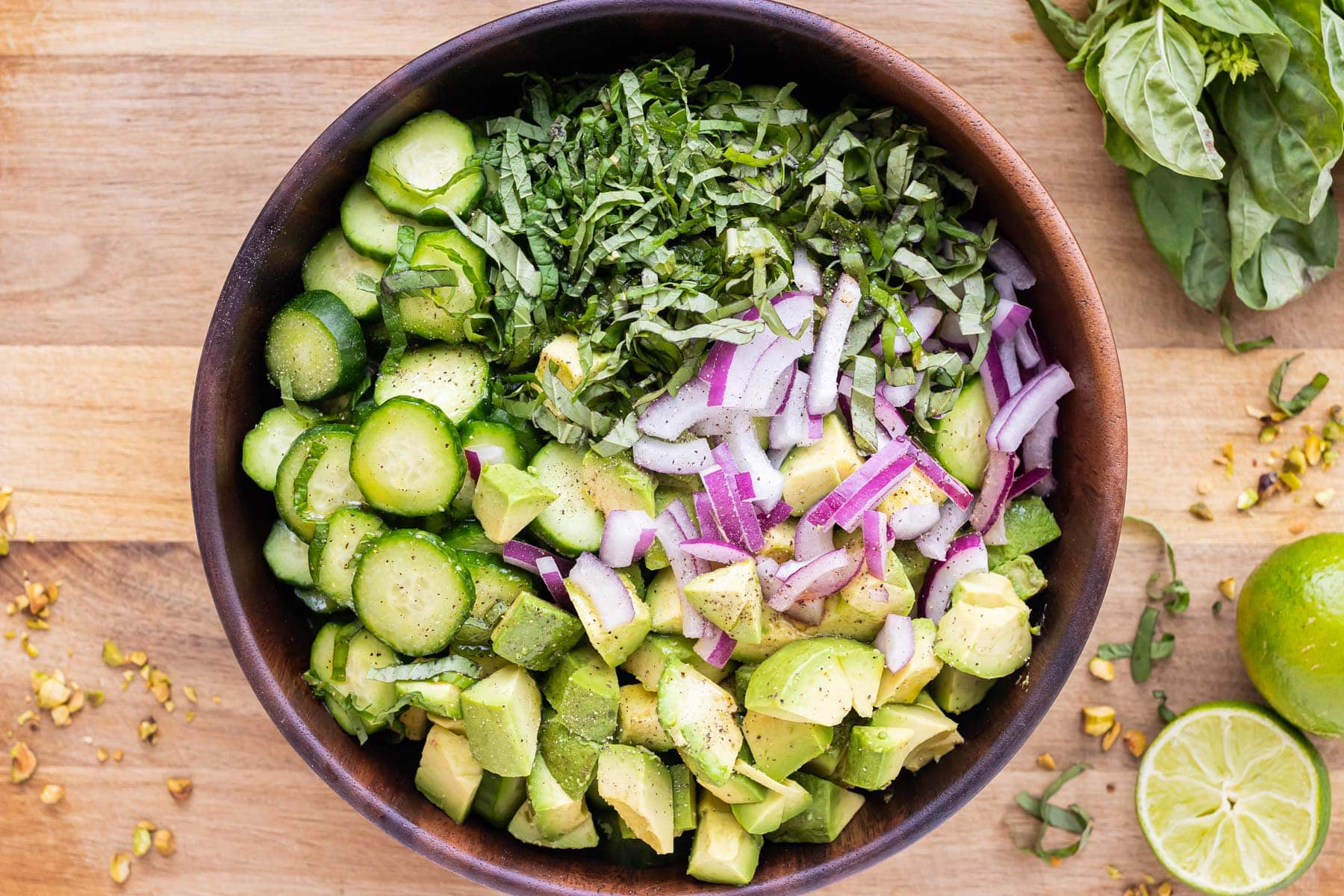 Prepared ingredients are added toa wooden bowl.