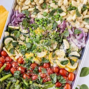 Sheet Pan Gnocchi Primavera after being roasted in the oven with vegetables, lemon juice, and fresh basil and tarragon.