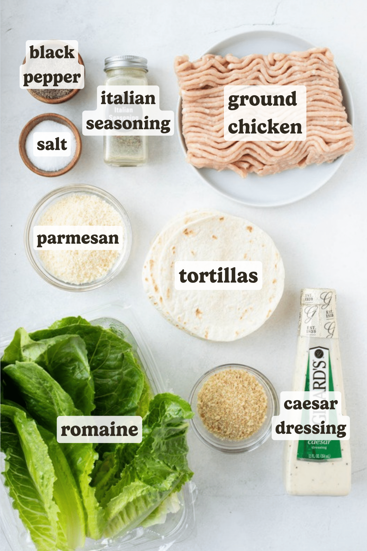 Labeled ingredients for chicken caesar smash tacos including ground chicken, parmesan, tortillas, caesar dressing, romaine, Italian seasoning, salt, and black pepper